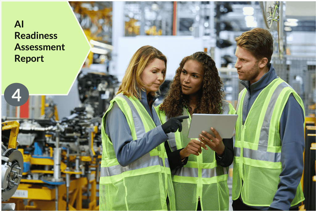 Group of people in plant facility with safety uniforms having a conversation, looking at a tablet